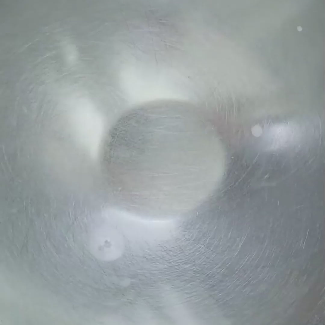 Galaxy Bomb bath product bubbling and dissolving in water, creating colourful effects.